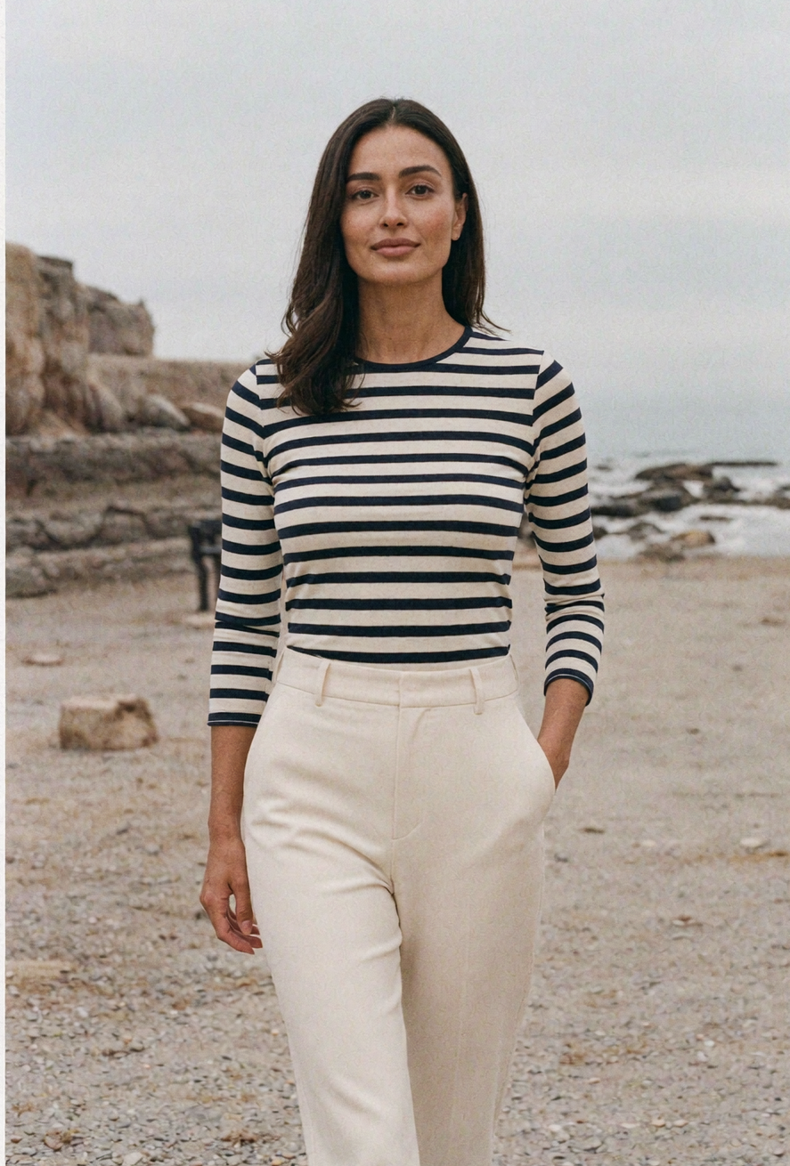 Woman in a navy and cream Breton striped top on a French seaside promenade