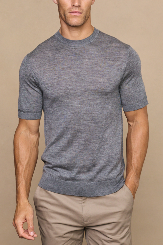 Man wearing a cedric grey marl fine knit t-shirt against a plain white background