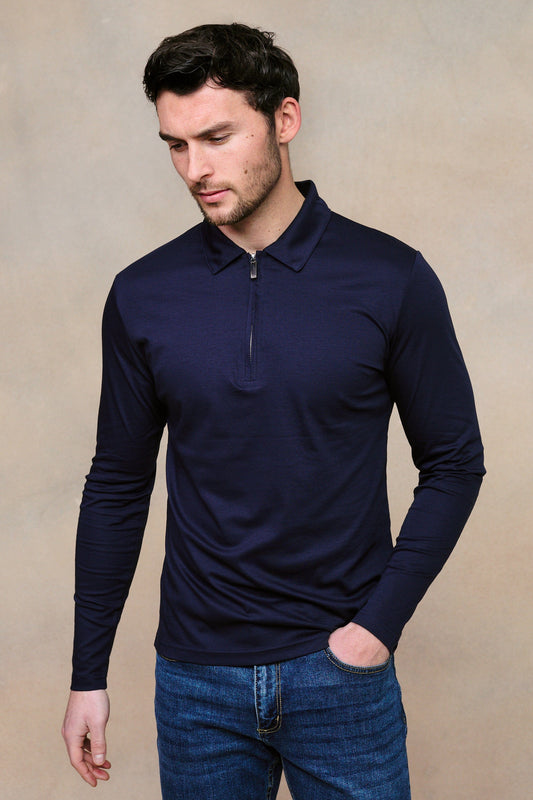Man wearing a mercerized long sleeve zip polo - navy against a clean background