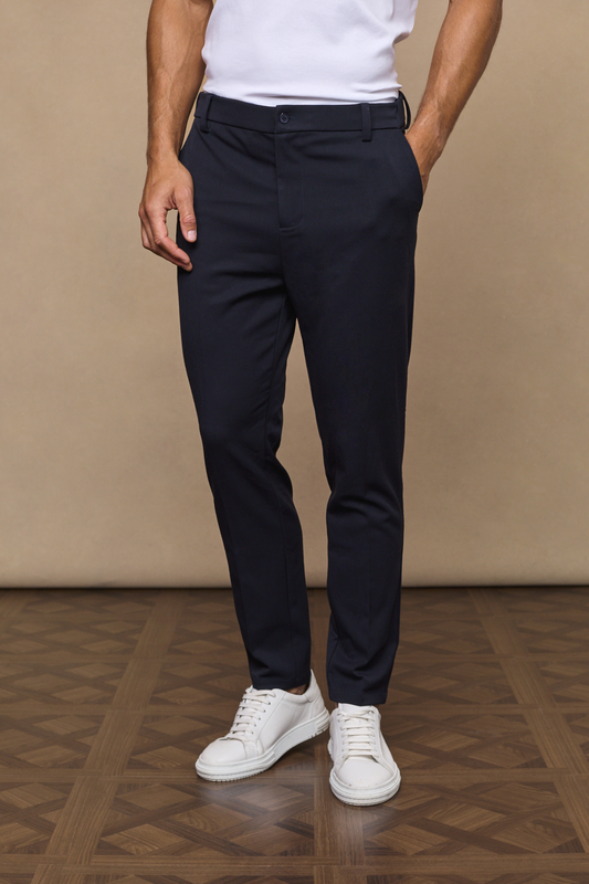 Man wearing a hugo tapered trousers - dark navy against a plain background