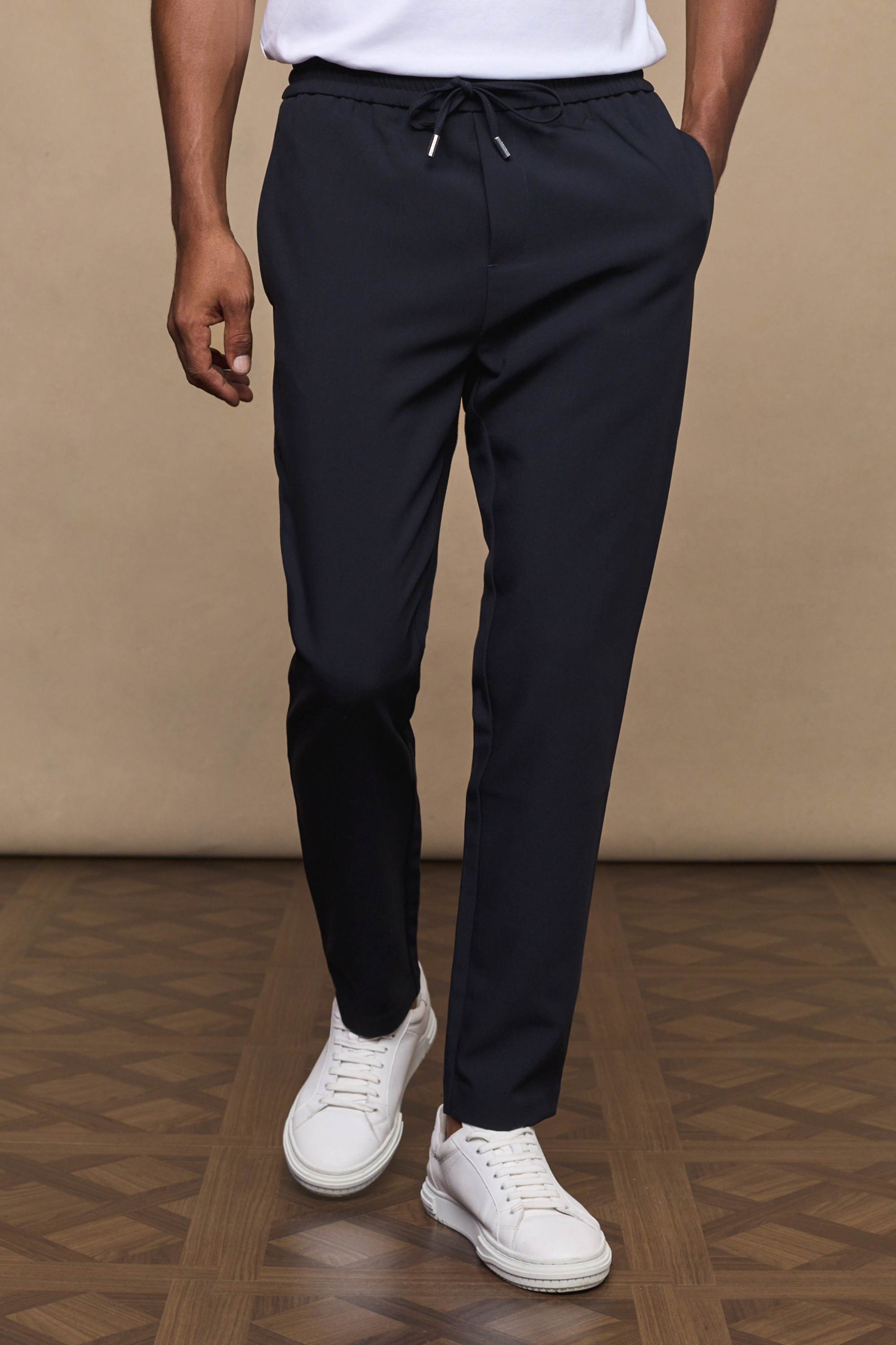 Man wearing an emilio daily tapered pants - deep navy against a clean background
