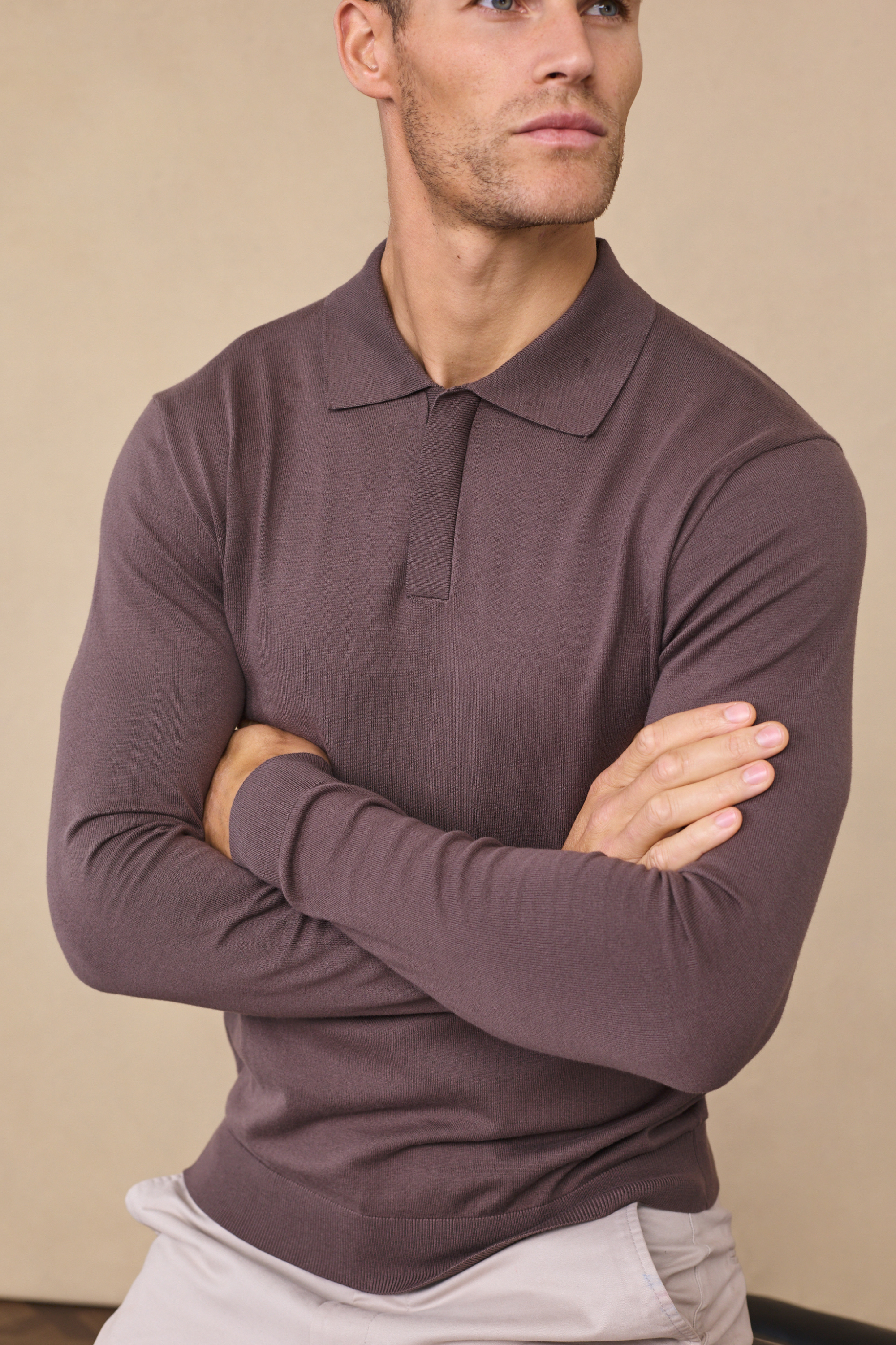 Man wearing a mocha andre long sleeve button-up polo against a clean background
