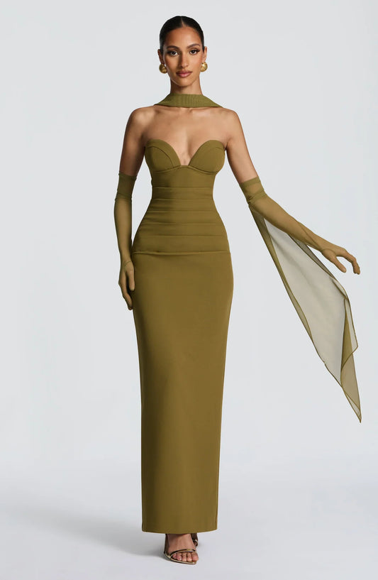 Woman wearing a maxi gown against a clean studio background