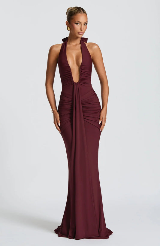 Woman wearing a maxi gown against a clean studio background