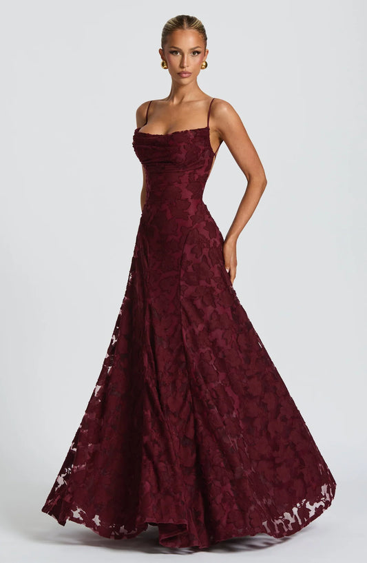 Woman wearing a maxi gown against a clean studio background