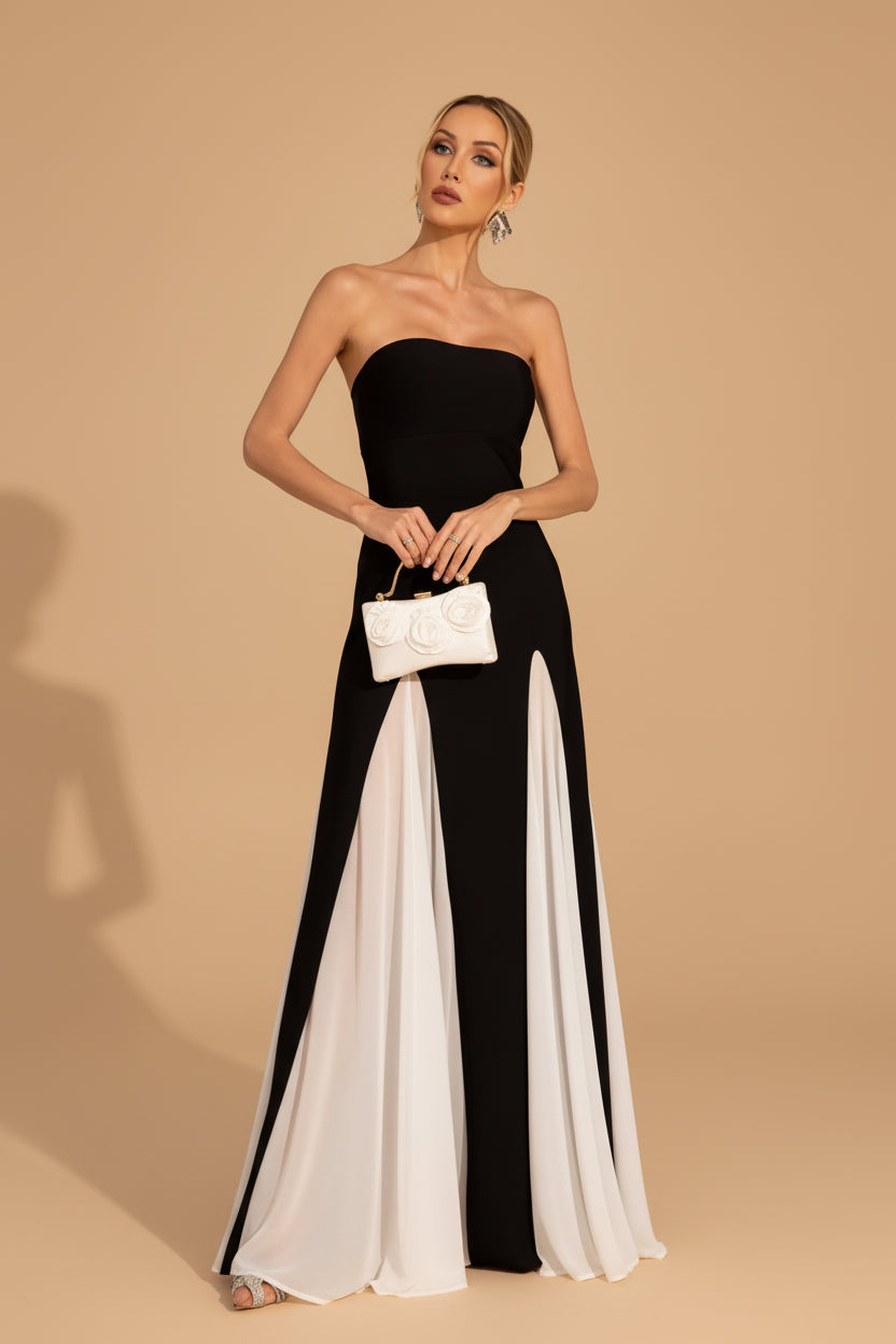 Woman wearing a black and white strapless jumpsuit on a white background