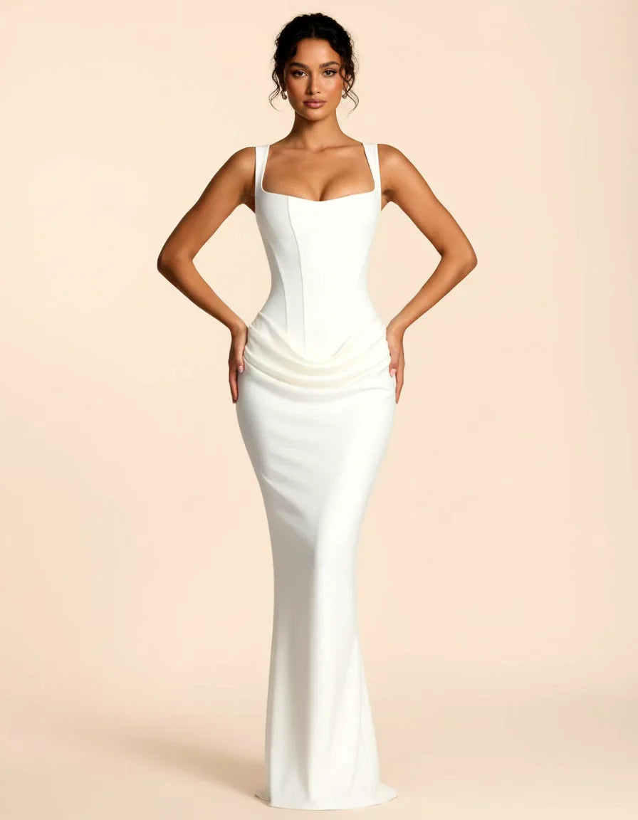 Woman wearing a maxi dress against a clean studio background