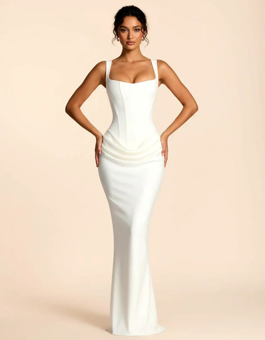Woman wearing a maxi dress against a clean studio background