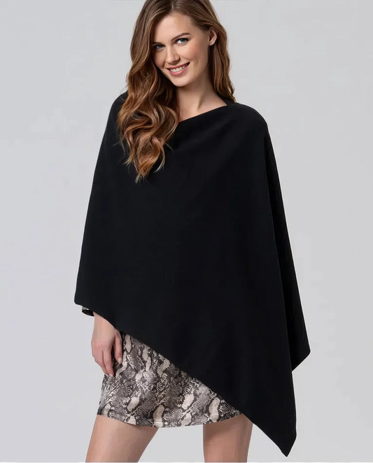 Woman wearing a sweater against a light beige background