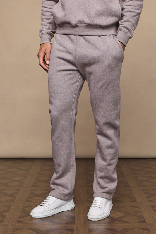 Man wearing a brown marl axel straight leg joggers against a minimal background