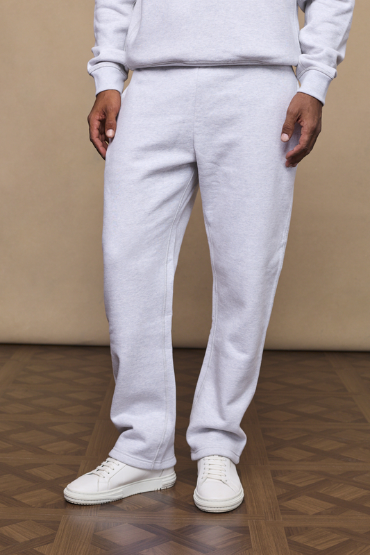 Man wearing a stone marl axel straight leg joggers against a minimal background