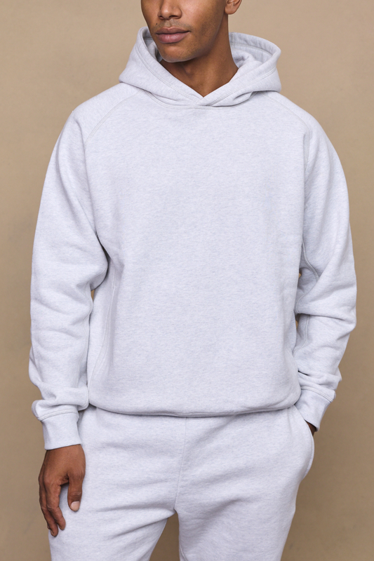 Man wearing a stone marl axel relaxed panel hoodie against a plain background