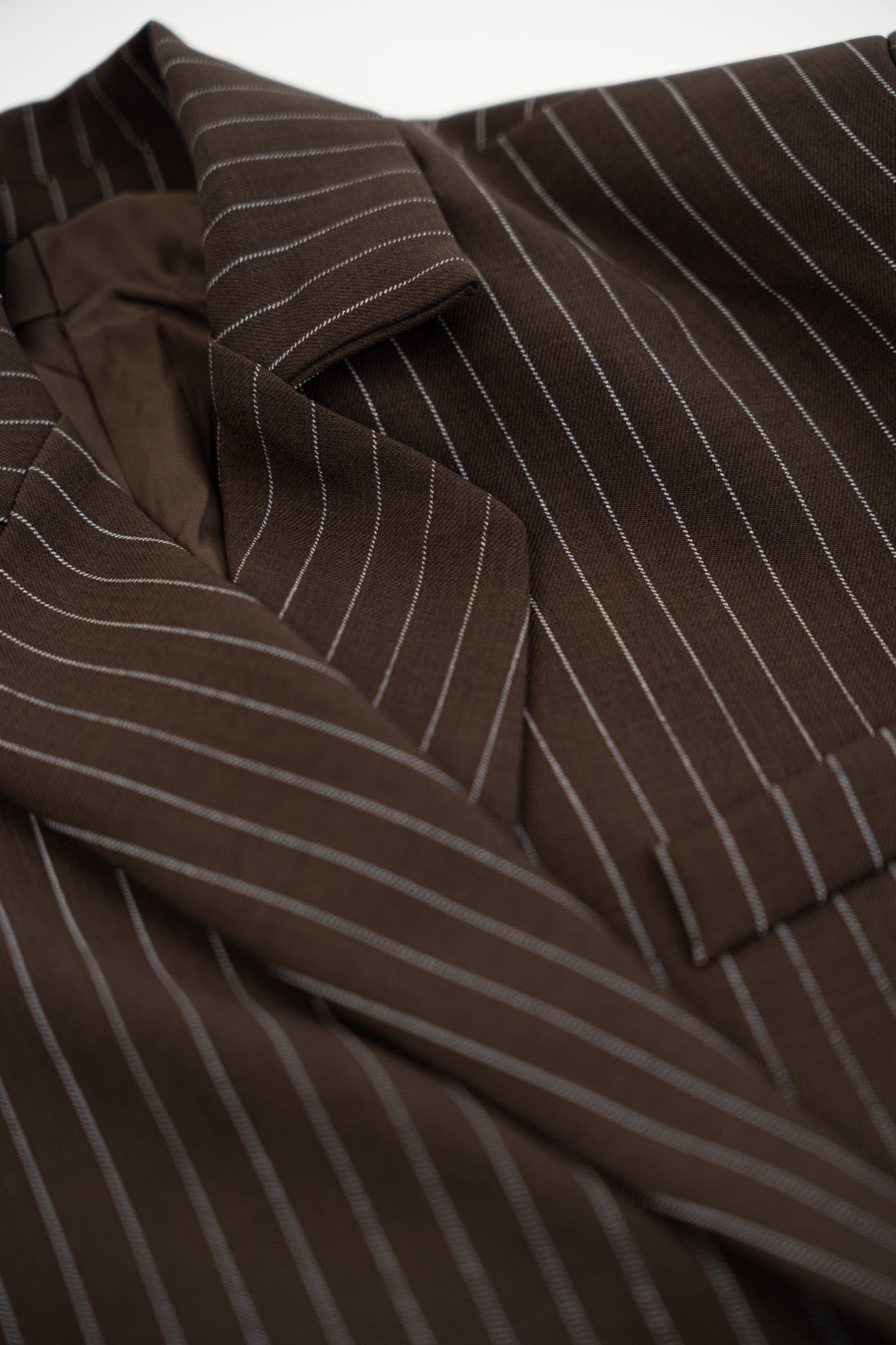 Close-up of a brown pinstripe suit jacket