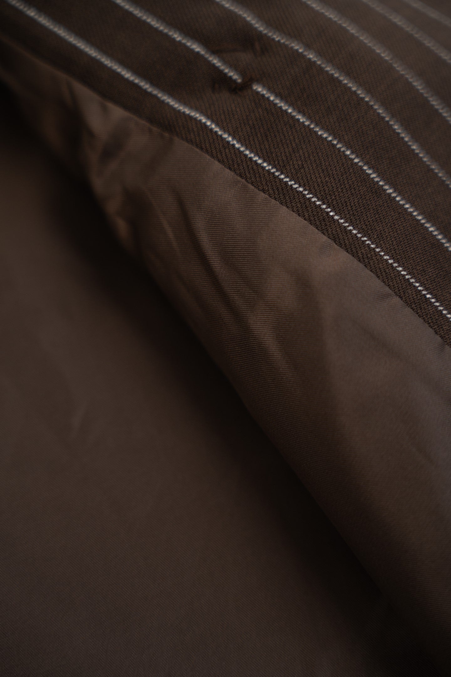 Close-up of a brown fabric texture with a mesh pattern