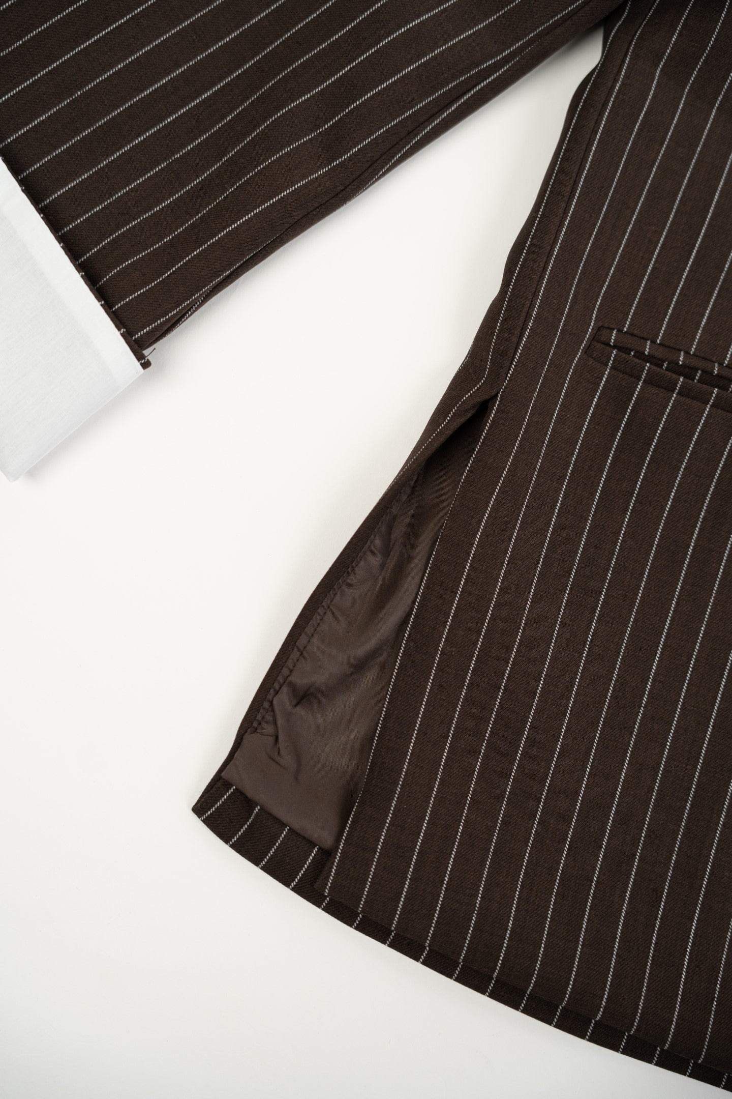 Brown pinstripe suit jacket on a white background