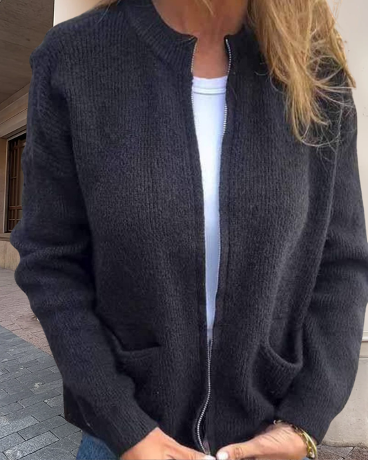 Woman wearing a cardigan against a soft neutral background