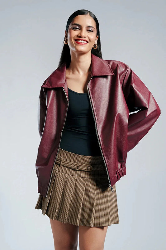 Woman wearing a jacket against a neutral studio background