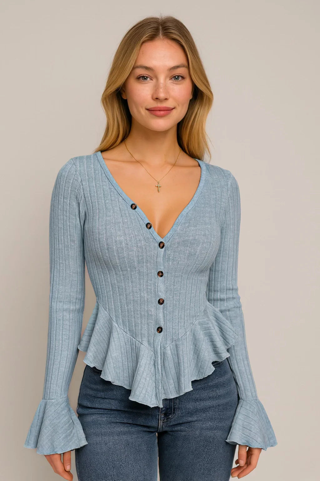 Woman wearing a blue cardigan against a soft neutral background