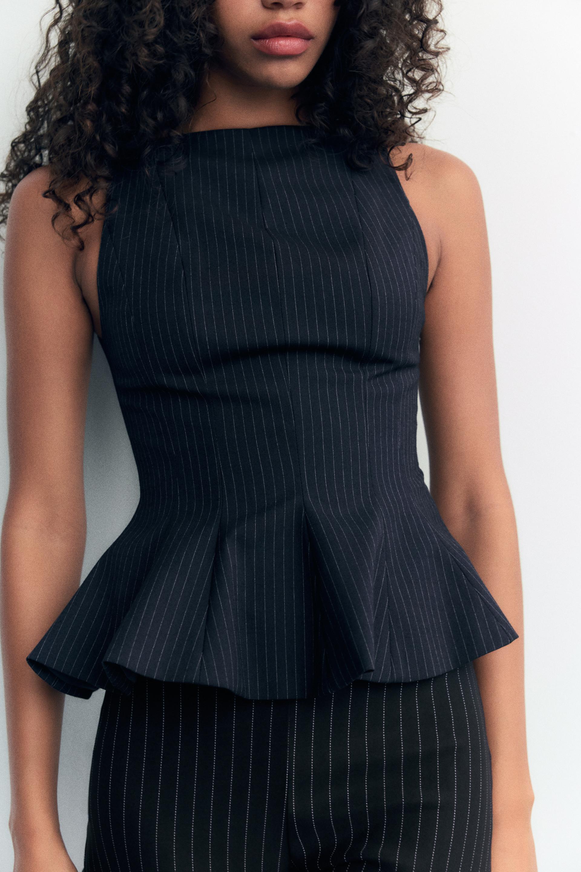 Woman wearing a top against a clean background