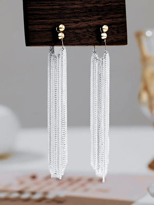 Woman wearing an earrings against a clean background