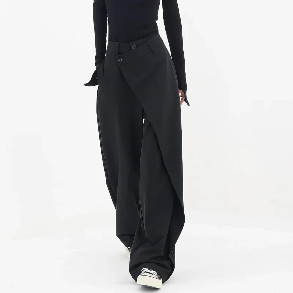 Woman wearing a trousers against a plain background