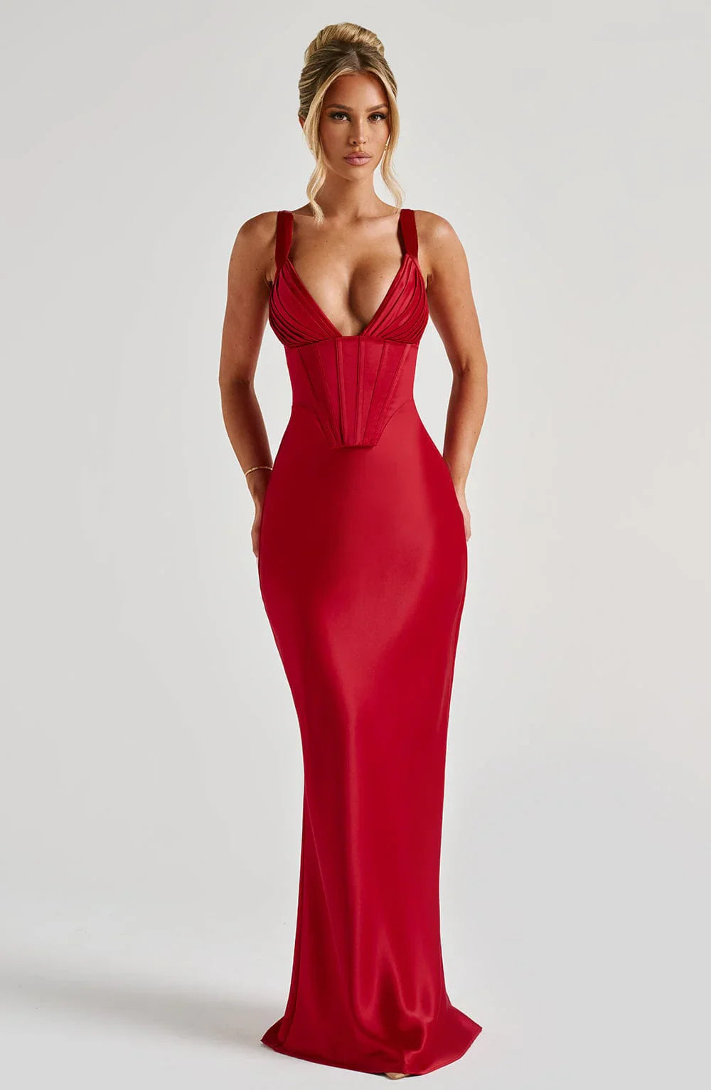 Woman wearing a maxi gown against a clean studio background