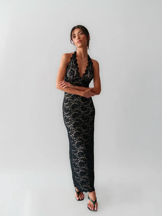 Woman wearing a lace gown against a clean studio background