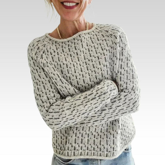 Man wearing a victoria | chic gray boat neck sweater against a light beige background