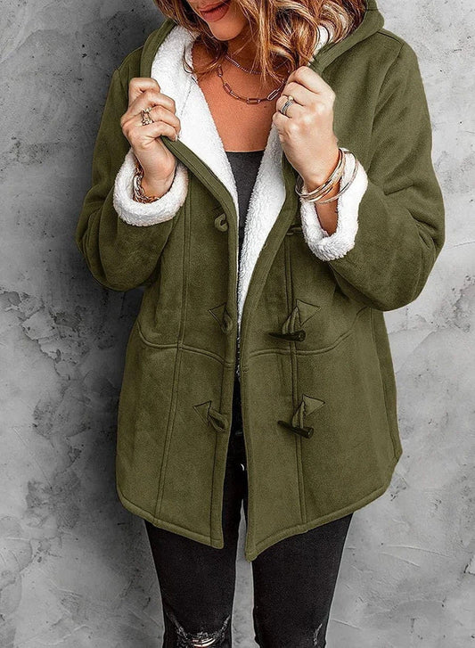Woman wearing a coat against a neutral studio background
