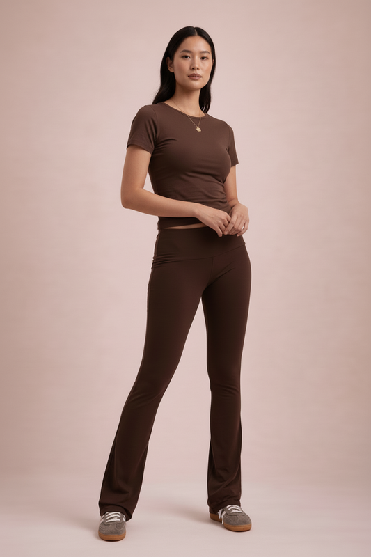 Woman wearing a brown short-sleeve top and pants on a beige background