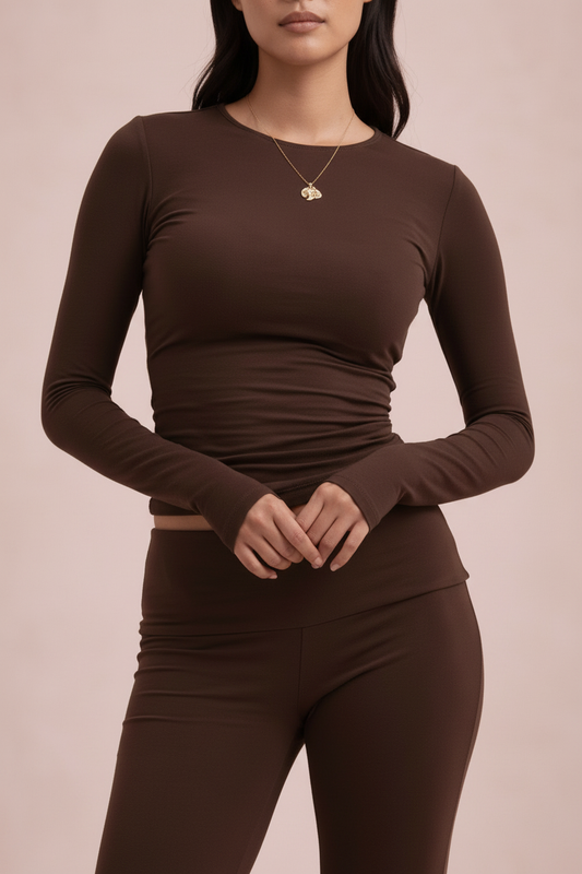 Model brown long-sleeve top and leggings on a beige background