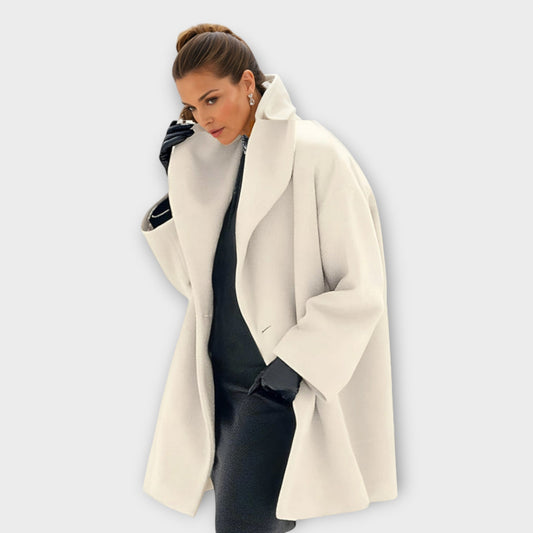 Woman wearing a jacket against a clean white background