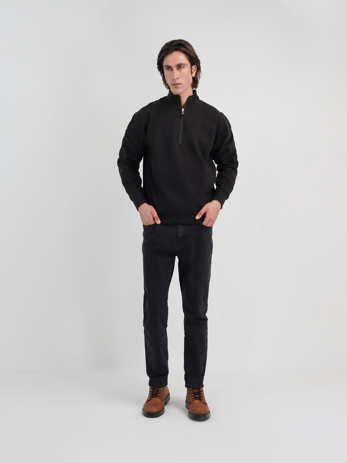 Man wearing a black sweatshirt against a clean background
