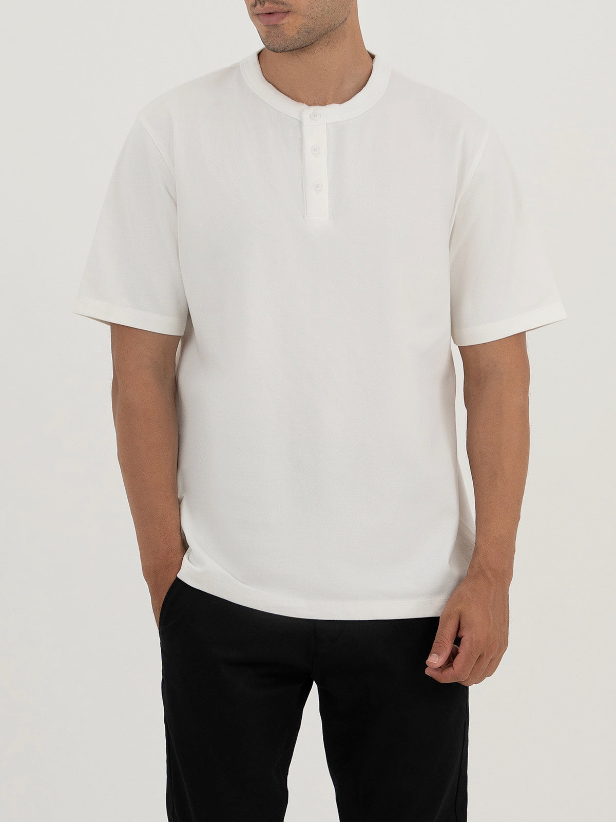 Man wearing a white t-shirt against a plain white background