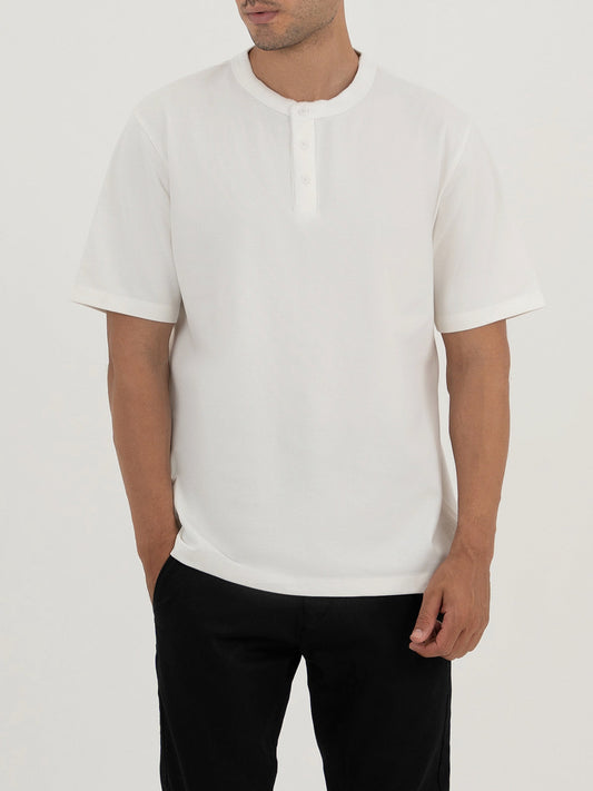 Man wearing a white t-shirt against a plain white background