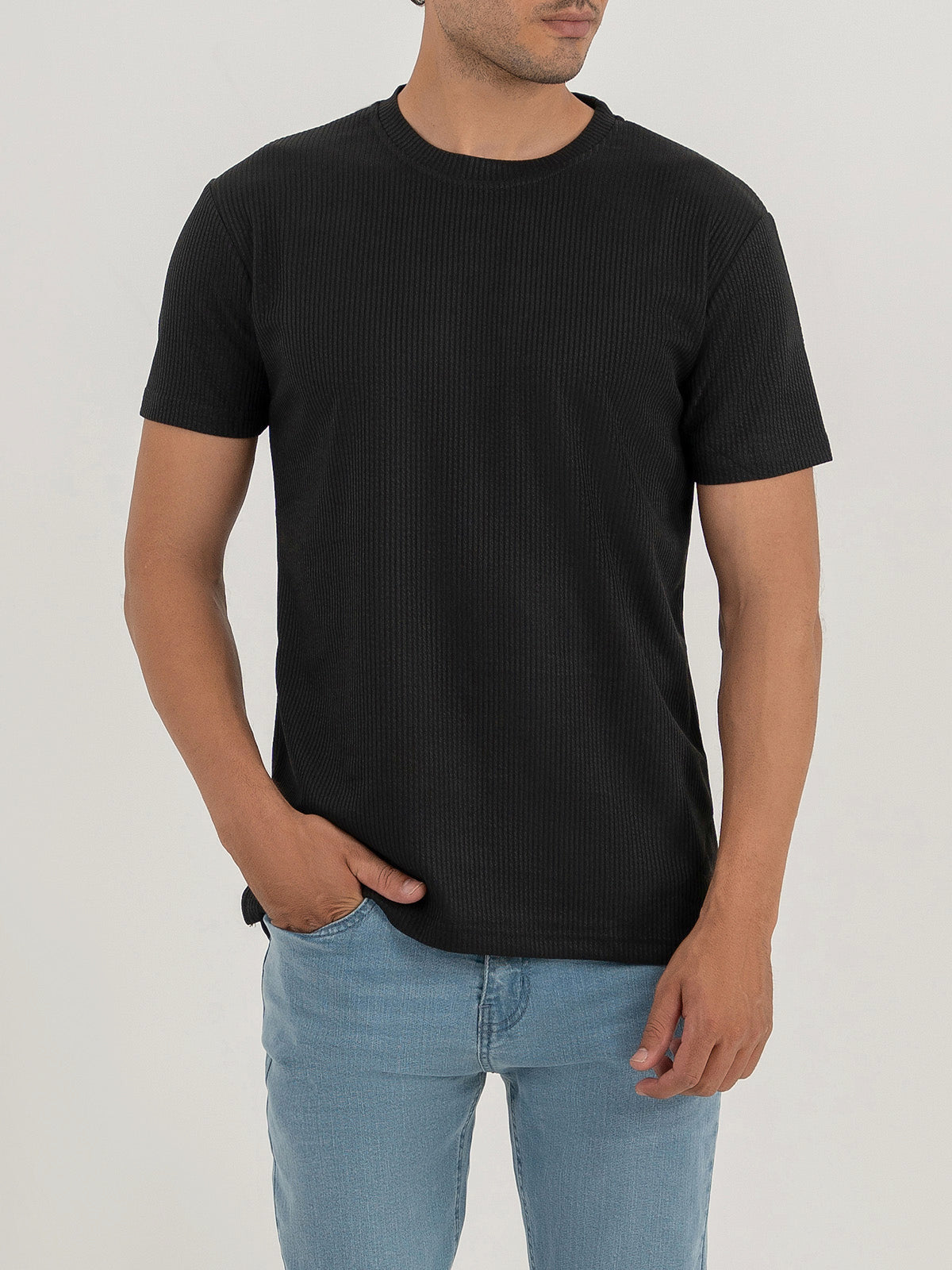 Man wearing a black t-shirt against a plain white background