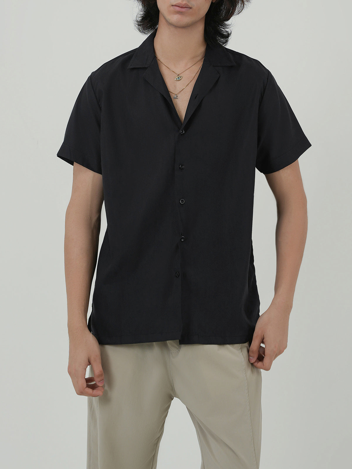 Man wearing a black shirt against a clean background