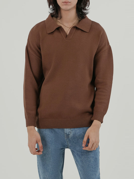 Man wearing a beige sweater against a light beige background